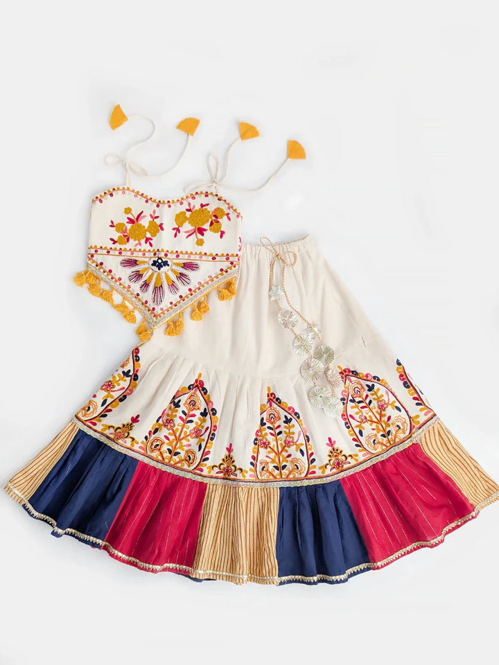 Colorful children's dress with intricate patterns on a white background