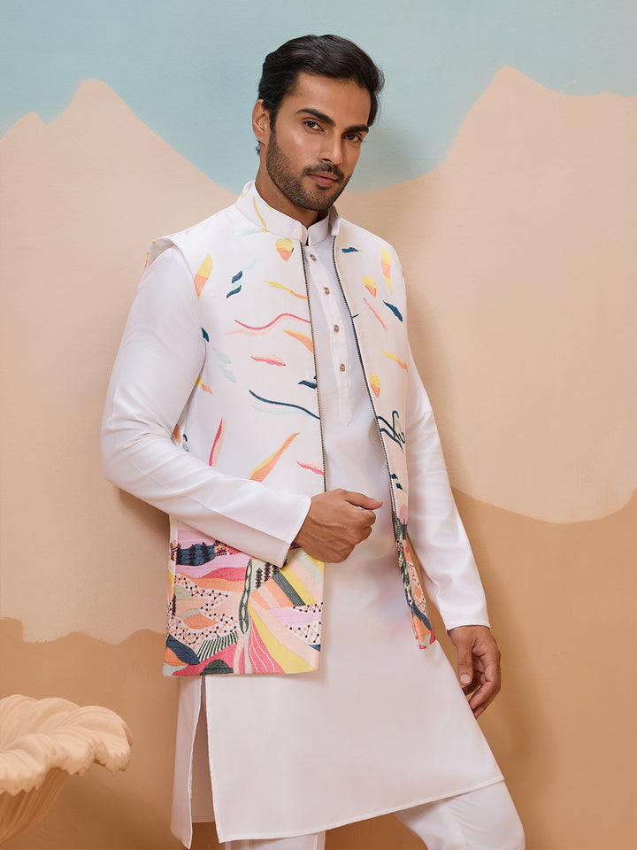 Man wearing a traditional outfit with a colorful jacket against a pastel background
