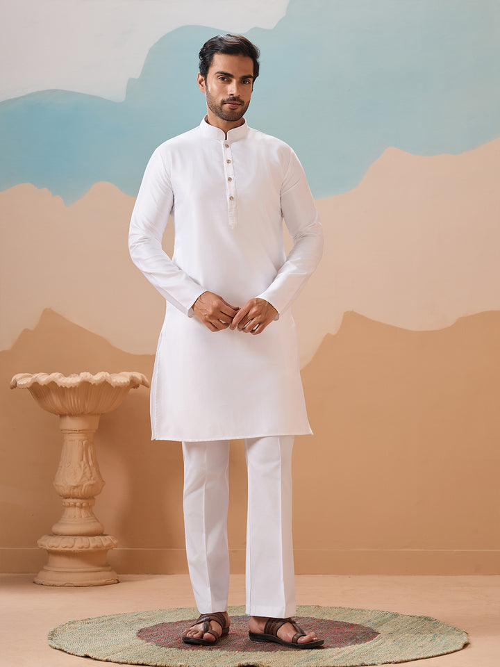 Man wearing a white kurta with a plain background