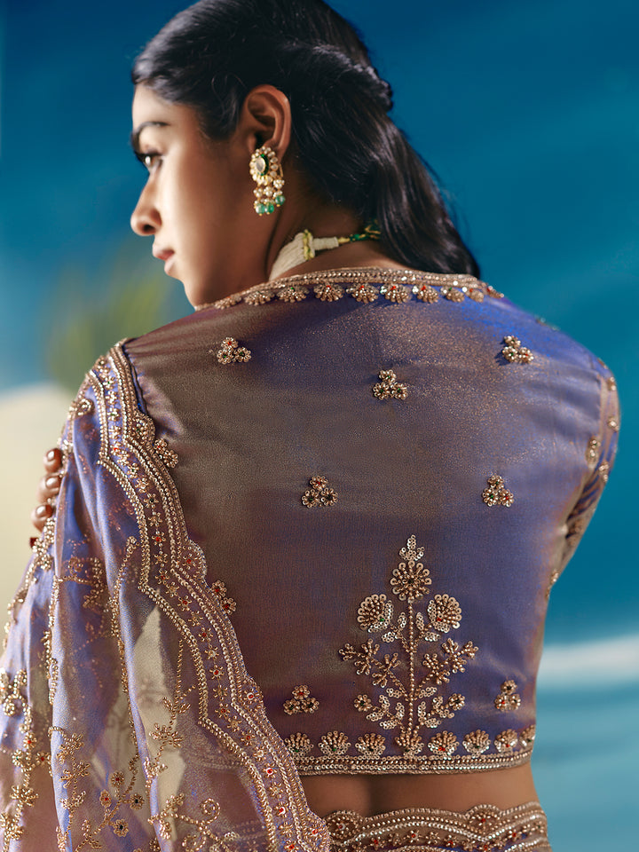 Woman wearing a traditional embroidered blouse with a blurred natural background