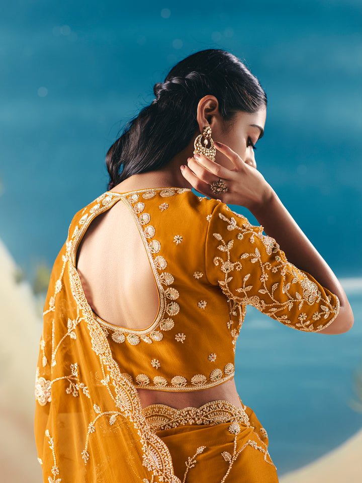 Woman in a yellow embroidered outfit with a blue sky background