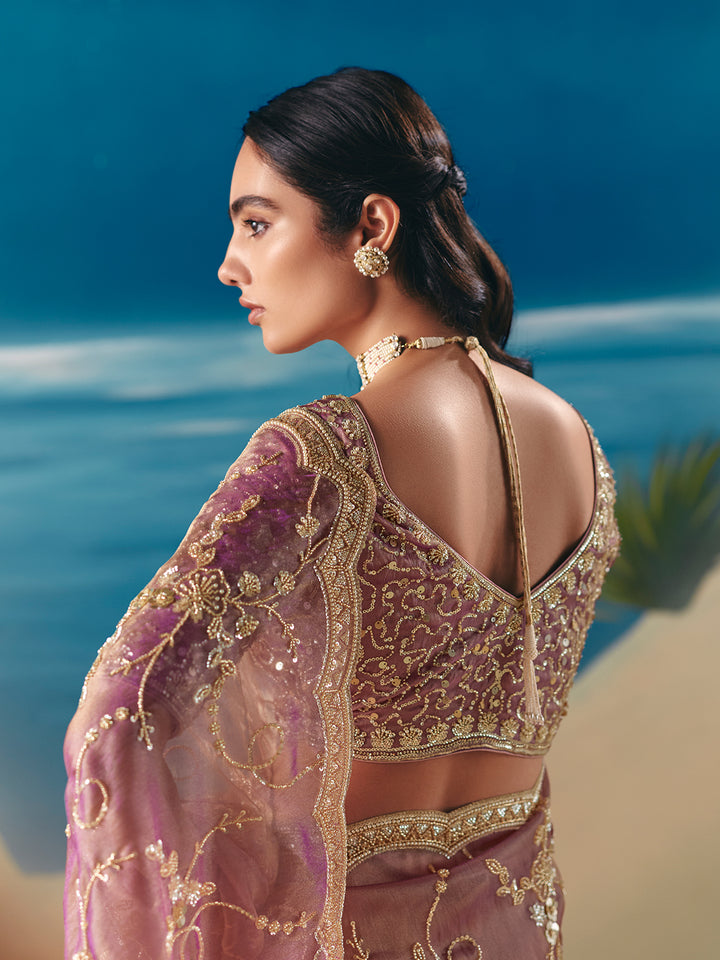 Woman in an embroidered traditional outfit by the ocean