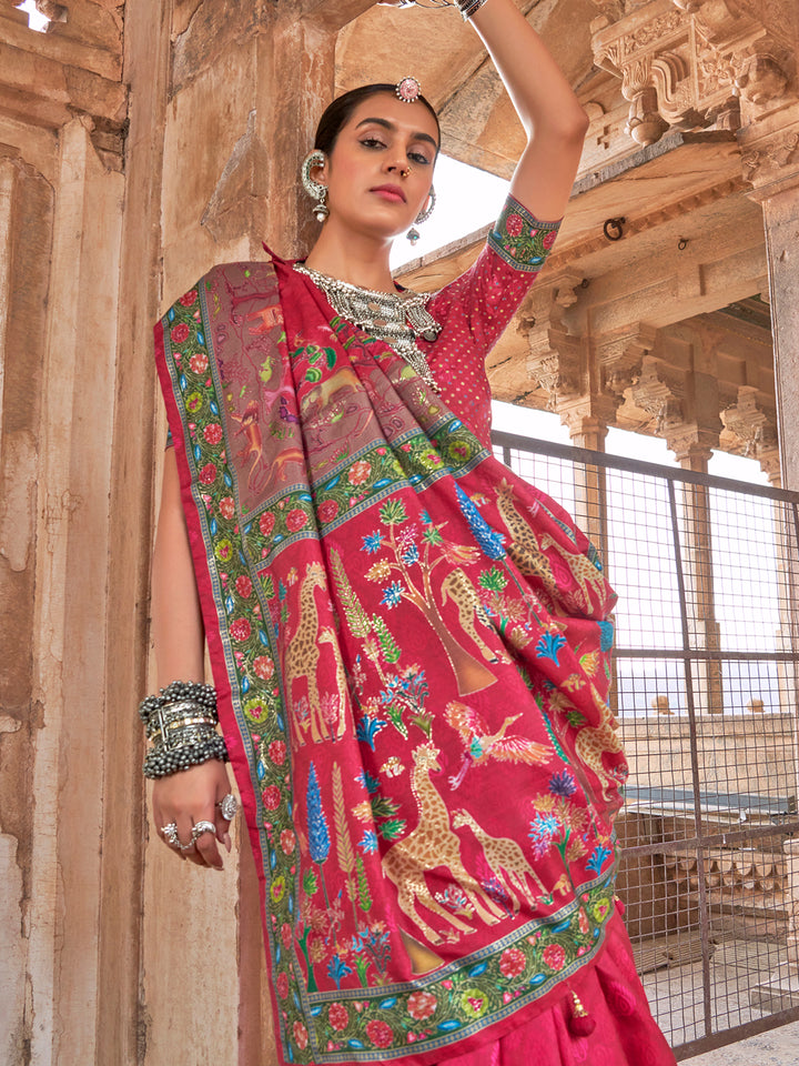 Woman in a vibrant saree with animal patterns standing in front of architectural elements.