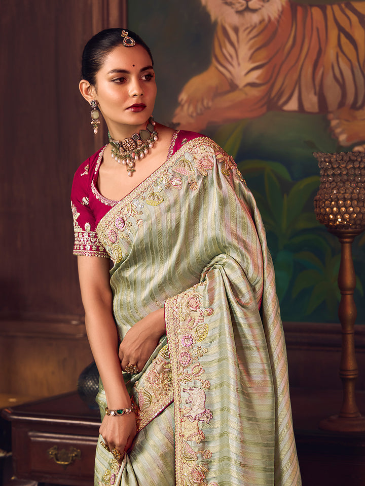 Woman in traditional saree with jewelry against a decorative background
