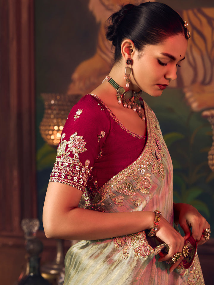 Woman in traditional Indian attire with jewelry against a decorative background