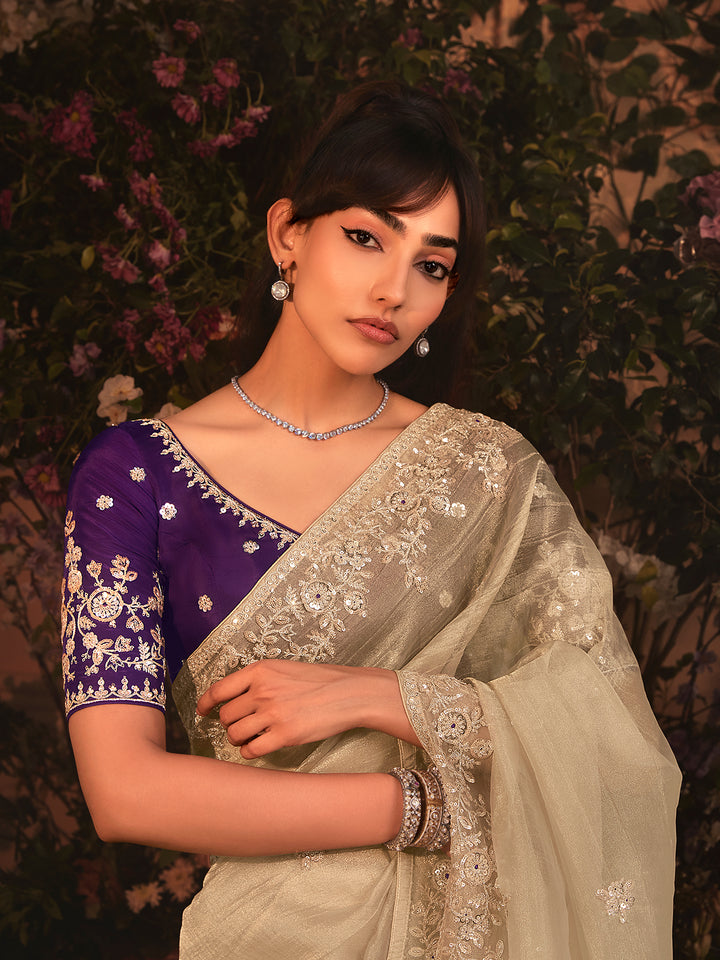 Beige Tissue Organza Saree with Heavy Embroidery & Stone Work Border – Party & Wedding Wear with Purple Silk Blouse