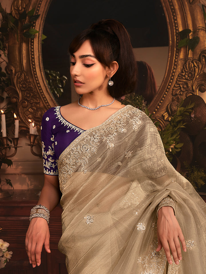 Beige Tissue Organza Saree with Heavy Embroidery & Stone Work Border – Party & Wedding Wear with Purple Silk Blouse