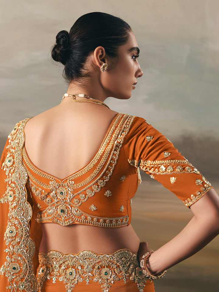 Woman wearing an orange embroidered traditional outfit with a blurred background