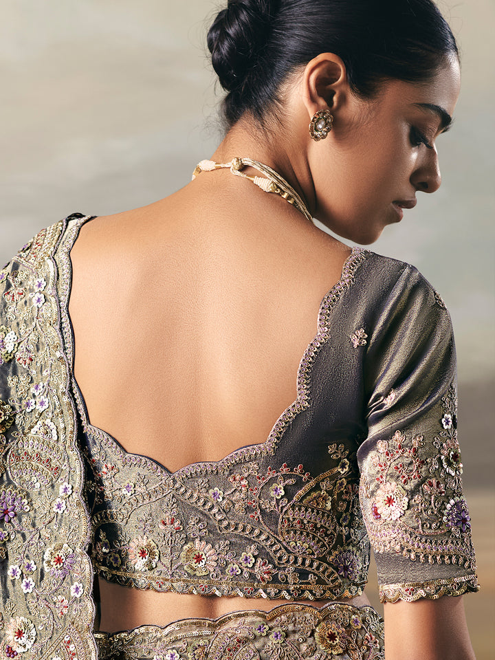 Woman wearing an embroidered saree with a blurred background
