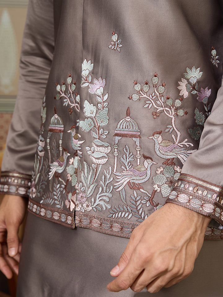 Close-up of a brown embroidered garment with intricate designs.