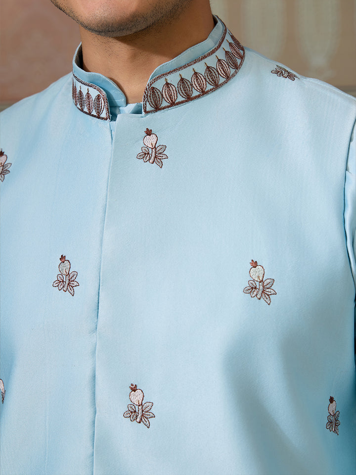 Light blue embroidered shirt with intricate patterns on a blurred background