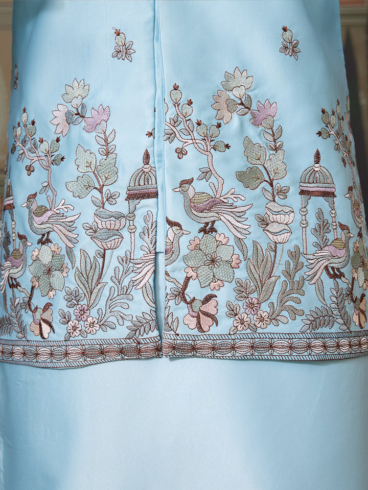 Light blue fabric with intricate floral and bird embroidery