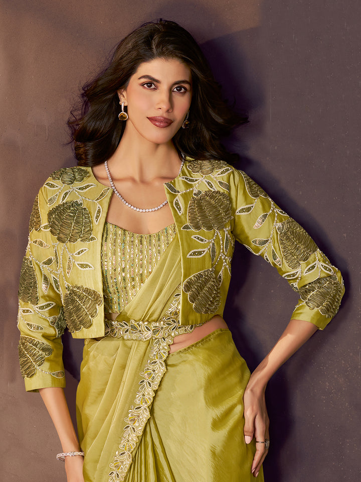 Woman wearing a green embroidered outfit against a brown background