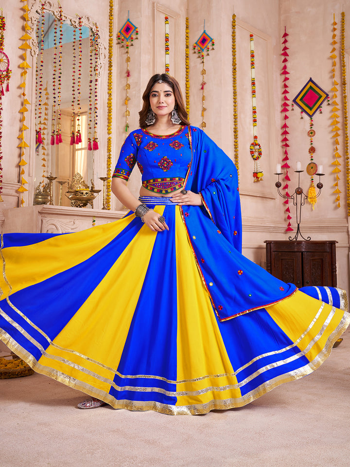 Woman in a blue and yellow saree with decorative background