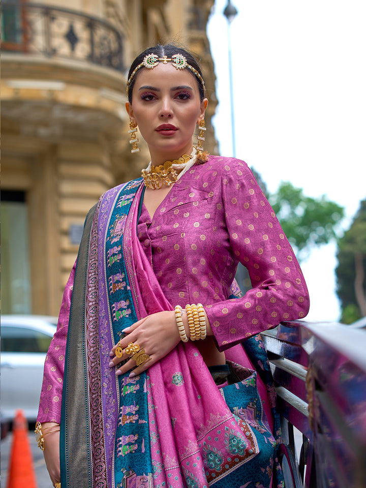 Woman in traditional pink saree with gold jewelry in an urban setting