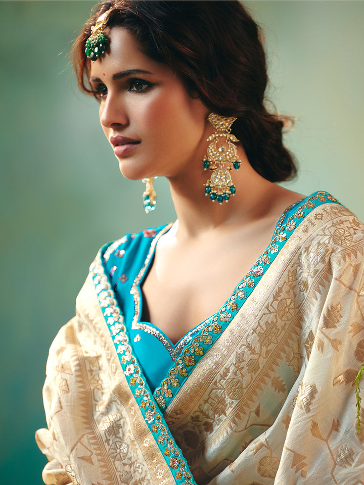 Off-White Dola Silk Saree with Blue Designer Blouse for Festive Occasions