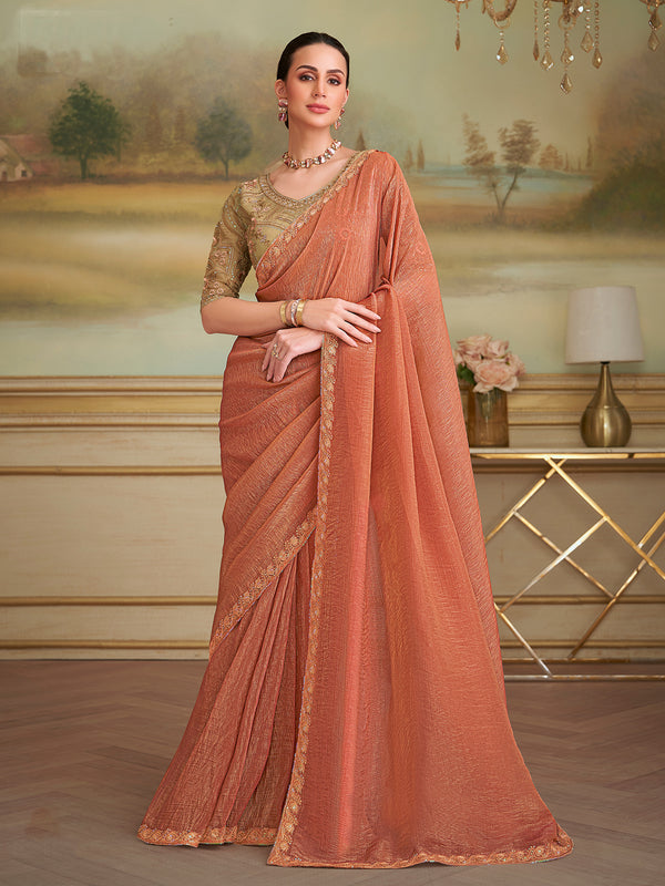 Woman wearing a peach saree with a scenic background