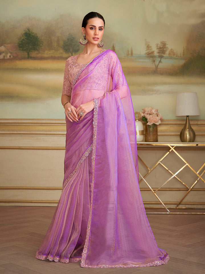 Woman wearing a pink saree with a scenic background