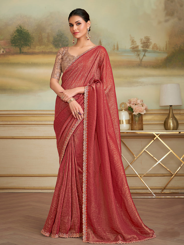 Woman wearing a red saree with a scenic background