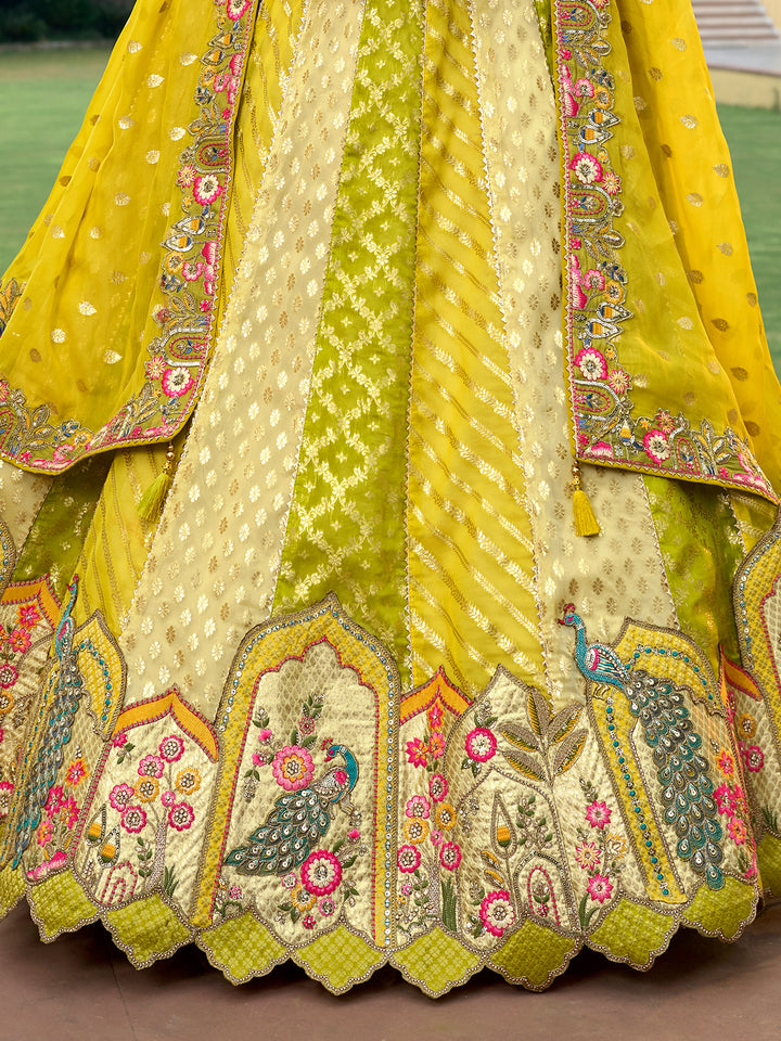Colorful embroidered fabric with peacock designs on a yellow background