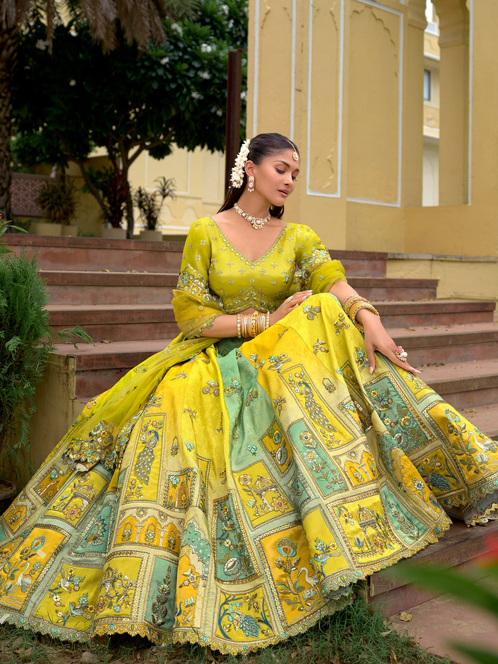 Woman in a yellow and green traditional outfit sitting on steps outdoors.