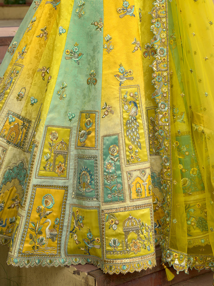Yellow and green embroidered fabric with intricate patterns
