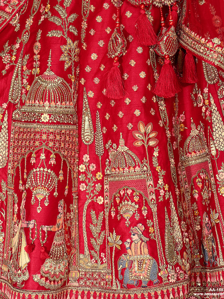 Close-up of a red fabric with intricate gold embroidery and tassels.