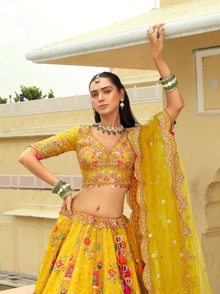 Woman in a traditional yellow and pink outfit with floral patterns, standing outdoors.