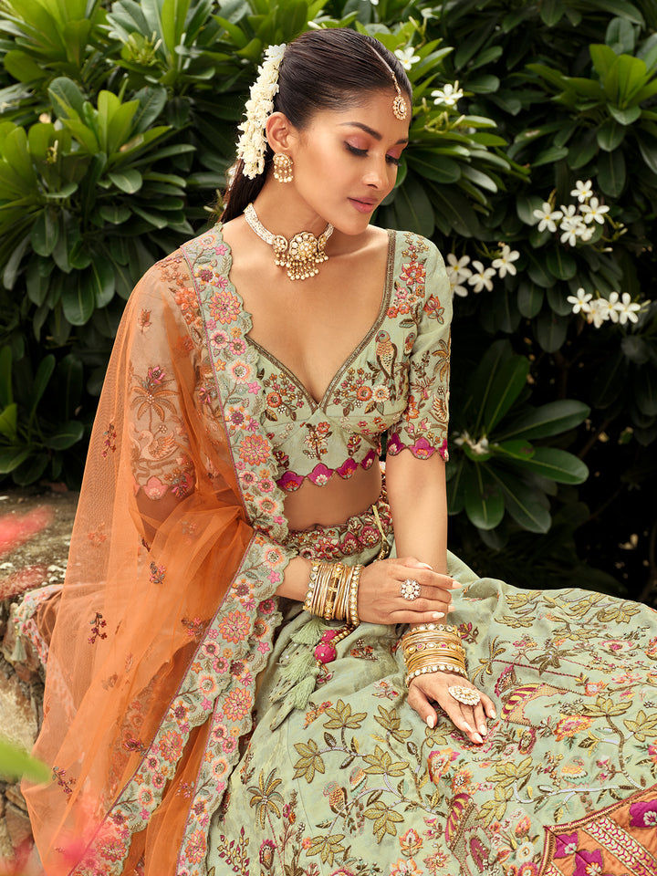 Woman in traditional outfit with floral patterns against a green foliage background