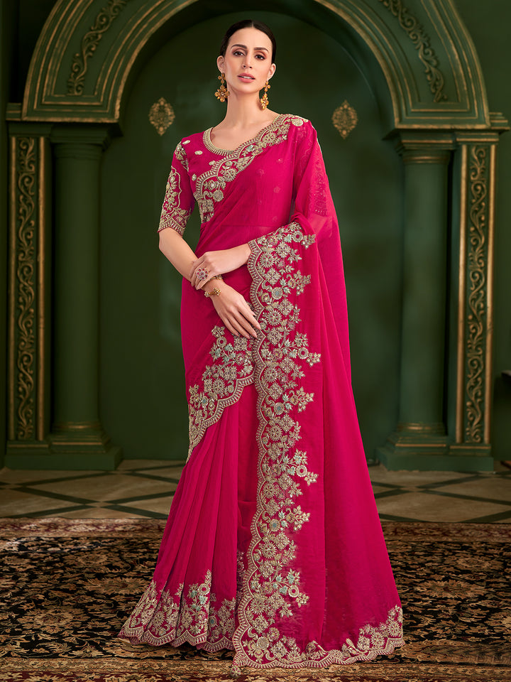 Woman wearing a pink saree with gold embroidery against an ornate green background