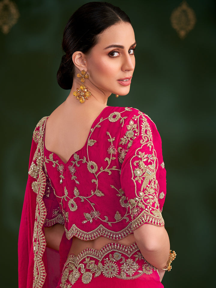 Woman wearing a pink embroidered traditional outfit with a dark green background