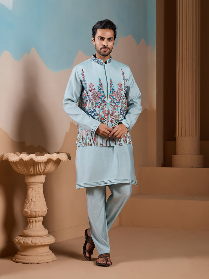 Man wearing a light blue embroidered kurta with pants in an indoor setting.