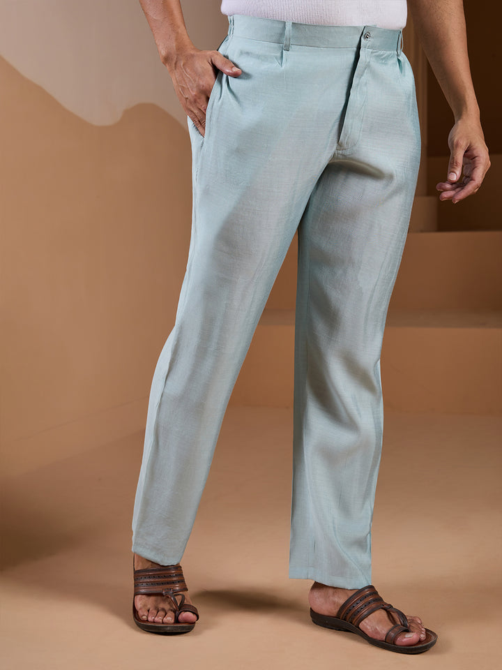 Light blue pants worn by a person on a beige background