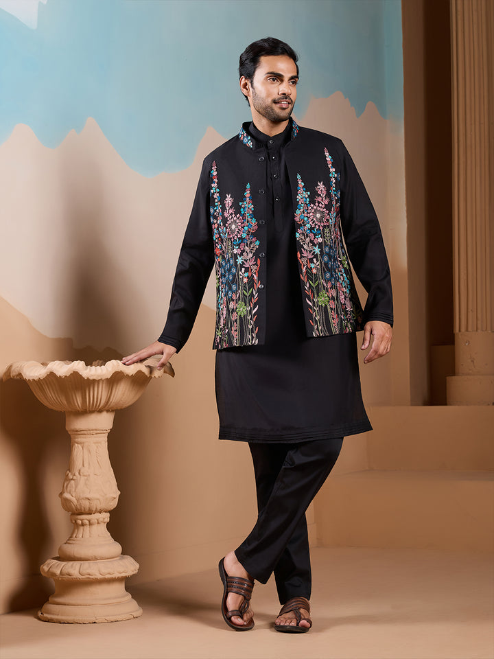 Man wearing a black kurta with floral embroidery in an outdoor setting